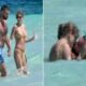 The singer Taylor Swift and the NFL star Travis Kelce were pictured kissing in the waves