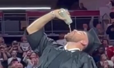 EXCLUSIVE: Travis Kelce FINALLY graduates college with brother Jason at the end of New Heights live show in Cincinnati - and Taylor Swift's boyfriend celebrates by necking a beer and screaming Beastie Boys lyrics!