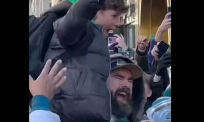 A living legend in the heart of Philly! Jason Kelce, surrounded by fans, lifting up the next generation—literally.