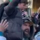 A living legend in the heart of Philly! Jason Kelce, surrounded by fans, lifting up the next generation—literally.